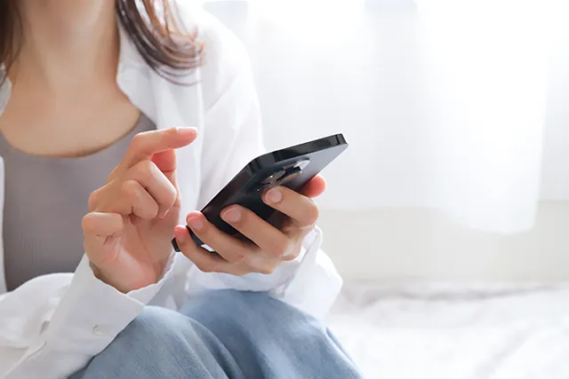 スマホで探し物をする女性